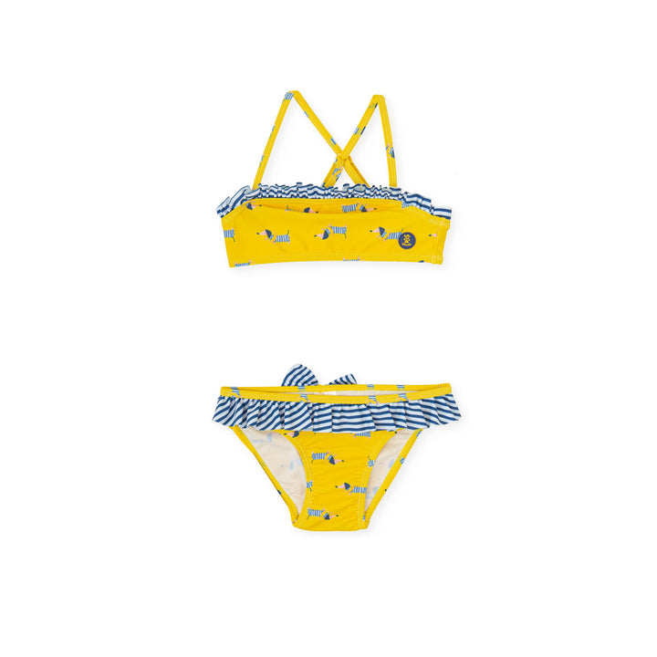 A vibrant yellow knitted bikini from the Tutto Piccolo kids' clothes line, designed with comfort and style in mind, perfect for a child's fun day at the beach or pool.