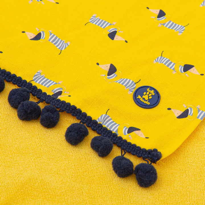 A cheerful yellow knitted towel with the Tutto Piccolo collection signature, designed with a canicross (dog running) motif for a fun and unique addition to a child's bath or beach gear.