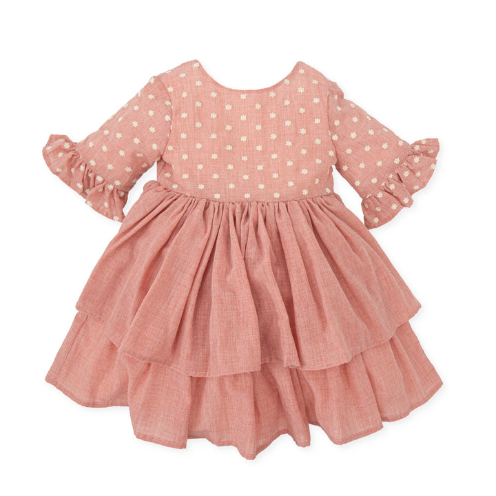 A delicate petal pink woven dress from the Tutto Piccolo baby girl collection, embodying elegance and comfort, ideal for special occasions or stylish everyday wear.