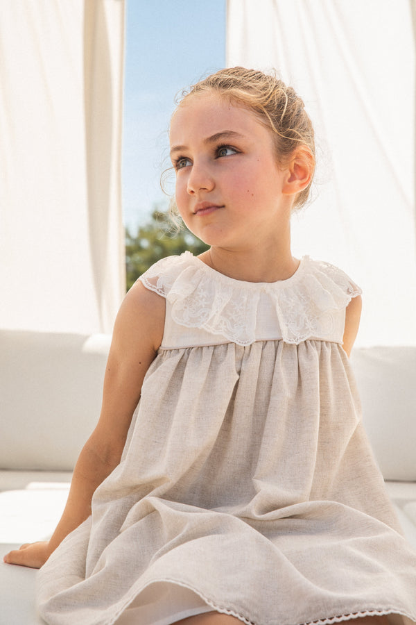 A chic sand-colored woven dress from the Tutto Piccolo kids' clothing line, offering a blend of elegance and comfort for baby girls, ideal for summer outings or special occasions.
