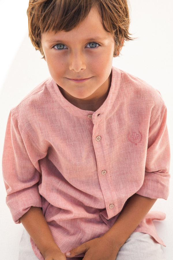 A delicate petal pink woven shirt by Tutto Piccolo, tailored for boys, merging classic design with a touch of summer flair, suitable for both casual and formal wear.