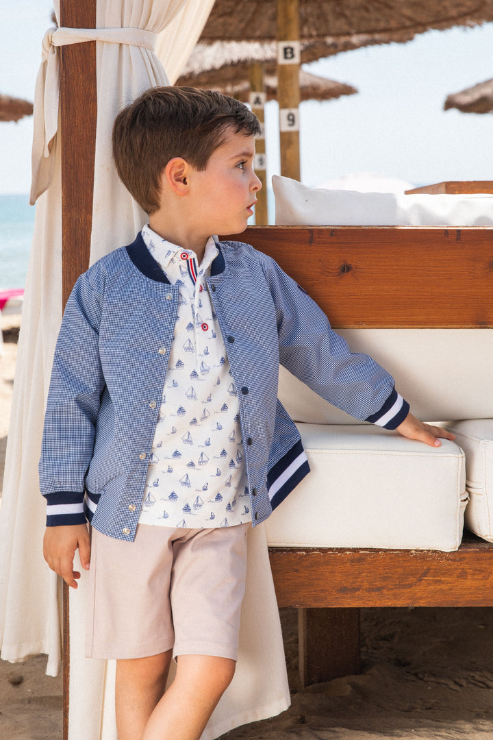 A classic navy blue knitted jacket from Tutto Piccolo, providing a versatile and stylish layering option for children's outfits, perfect for cooler summer evenings.