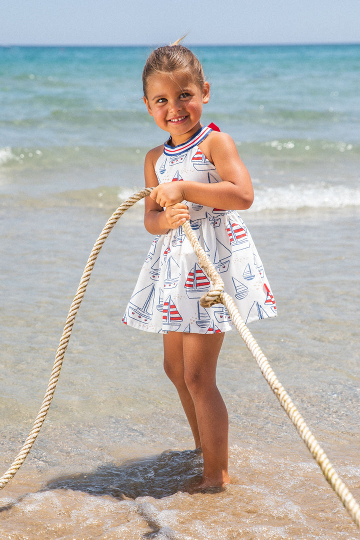 A sophisticated navy blue woven dress from the Tutto Piccolo baby girl collection, featuring a timeless design with a comfortable fit, ideal for special occasions or everyday elegance.