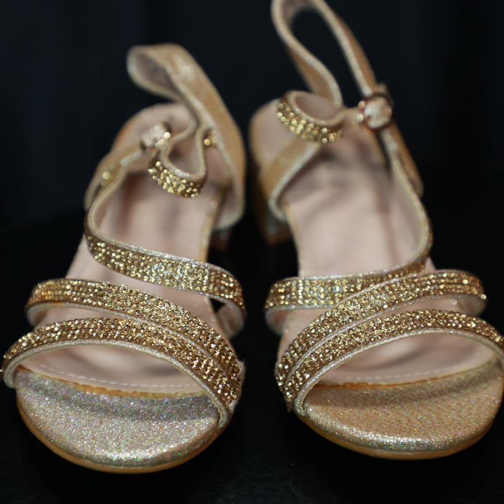 Gold open toe low heel sandals for girls.