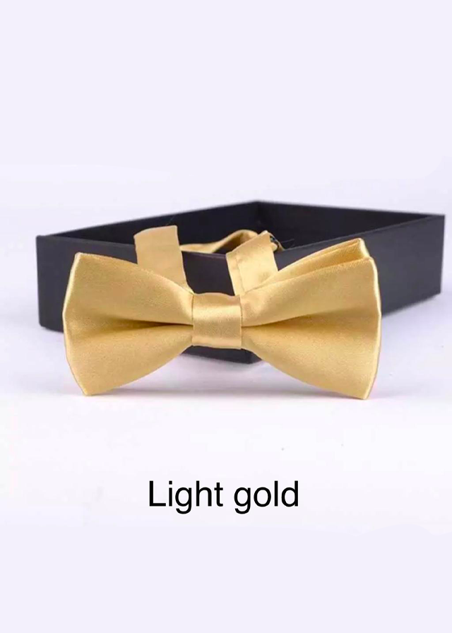 Elegant gold boys bow tie with Kids Chic branding, a symbol of style